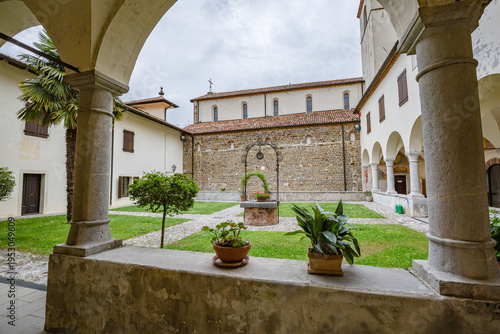 The Abbey of Rosazzo Italy - May 2021: Framed View of the Abbazia di Rosazzo Cloister through Stone Arches