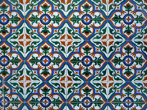 Tableau sur toile Fragment of building wall with glazed ceramic tiles, embossed vintage Mudejar, close up