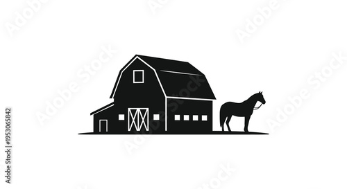 Silhouette of a horse standing beside a traditional barn