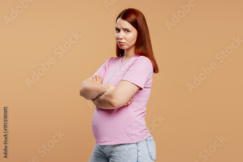 Фотография Pregnant woman feeling upset, showing annoyance with crossed arms and a sulking
