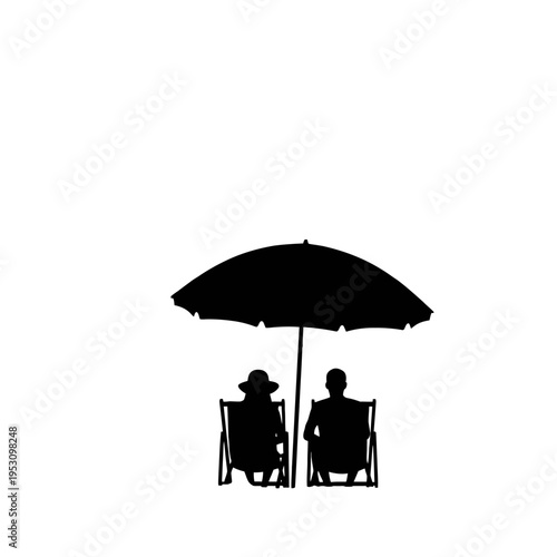 Two silhouetted people relaxing in beach chairs under a large umbrella at the seaside.