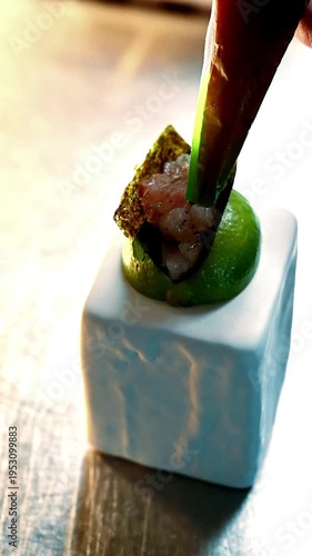 Elegant culinary presentation. Artistic dish featuring bright green mousse and seared fish