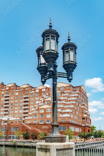 Urban waterfront scene with vintage lamp post and residential architecture Baltimore Maryland USA