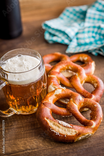 Beer Mug and Soft Pretzels on Rustic Wooden Table. Oktoberfest Snack and Bavarian Pub Food