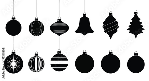 Assorted black and white holiday ornaments hanging from strings in a festive display