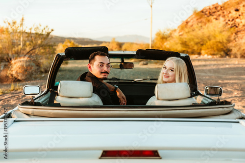 happy young couple in convertible car