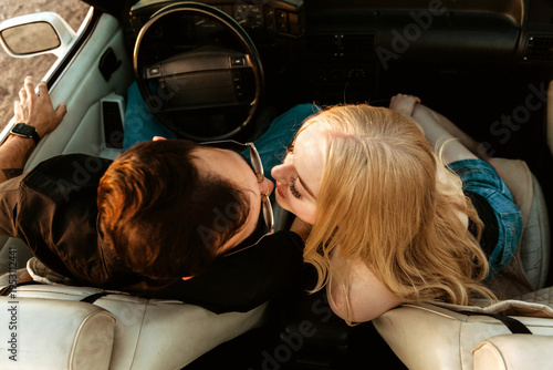 young couple in car about to kiss