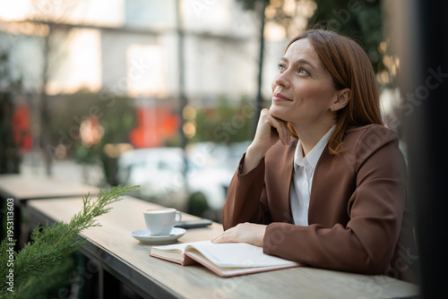 Fotografía Woman dreaming on cafe terrace thinking about future