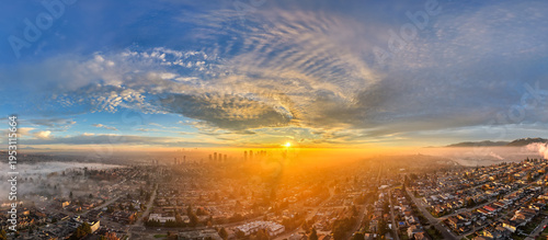 Sunrise Over Foggy Burnaby Skyline With Vancouver Towers and Golden Light Over BC Cityscape