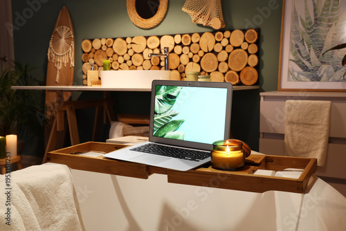 Bathtub with laptop and bur...