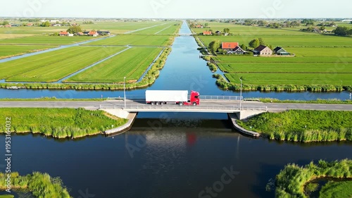 Truck Crossing Bridge Over Canal in Polder Landscape
