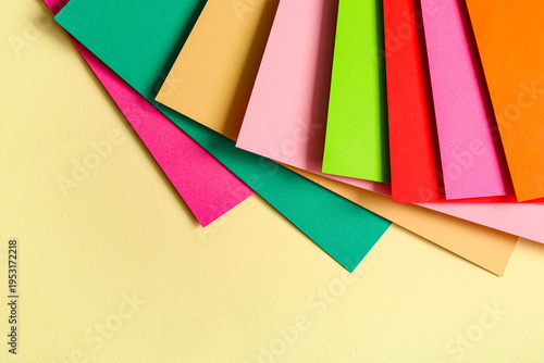 Colorful paper sheets on be...
