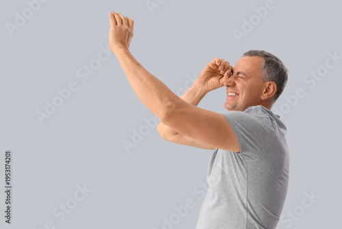 Mature man looking through ...