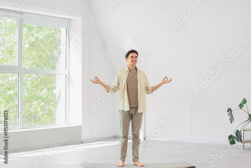 Happy young man meditating ...