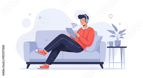 Young man with headphones using tablet on sofa, relaxing at home, enjoying online content