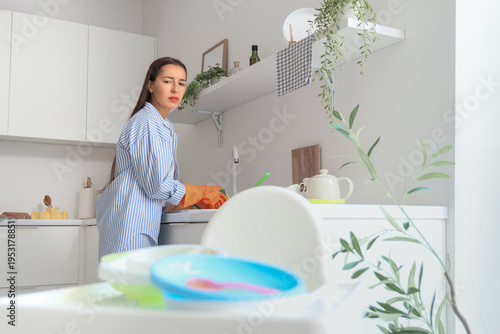 Tired mother washing dishes...