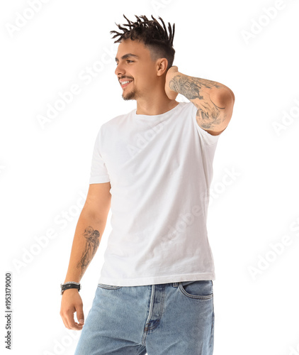 Tattooed young man with dreadlocks on white background
