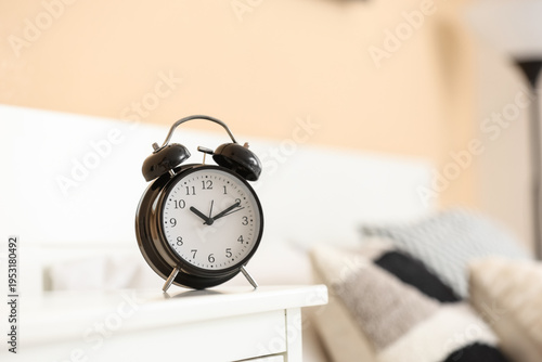 Black alarm clock on table ...