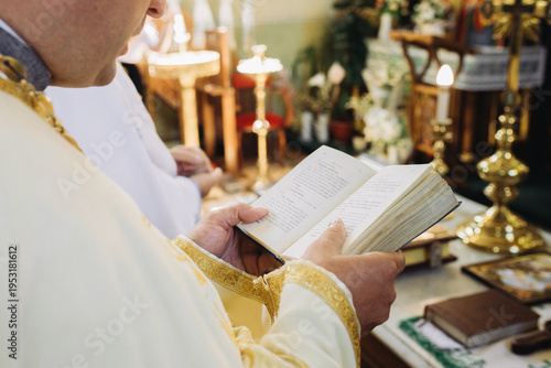 Tableau sur toile Priest reading from prayer book during christian wedding ceremony