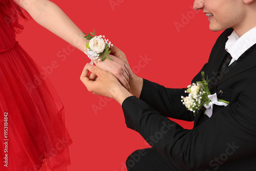 Young boy tying corsage aro...