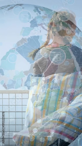 Vertical video: Girls entering wrapping blanket starting globe overlay for tech demo at ocean rail