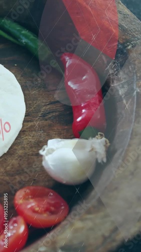 Vertical video: Overlay sweeping, camera panning right, revealing chiles, garlic, cheese for promo