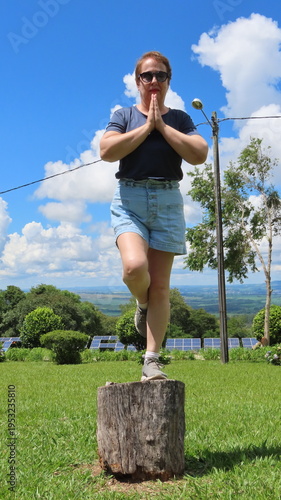 woman balancing on the tree trunk