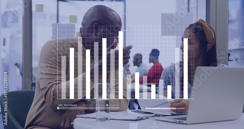 Vertical video: Mentor leaning, chart appearing as pair checking biz data on laptop,papers