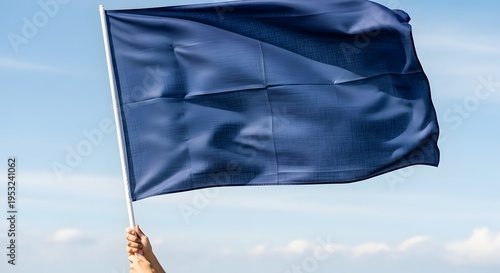 A hand holding a blue flag waving in the sky with clouds 2026 Commonwealth of Nations