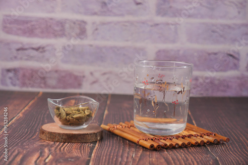 Photography Hot water with cardamon sits on a wooden table