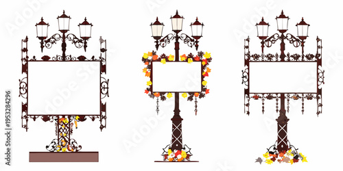 Three ornate street lamps with blank rectangular signs and autumnal foliage