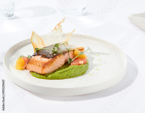 Gourmet Seared Salmon with Vibrant Green Pea Puree and Citrus Garnish