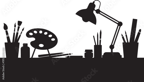 Black silhouette studio desk with lamp and painting supplies