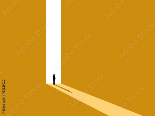 confident businessman stood in front of a large, brightly lit door