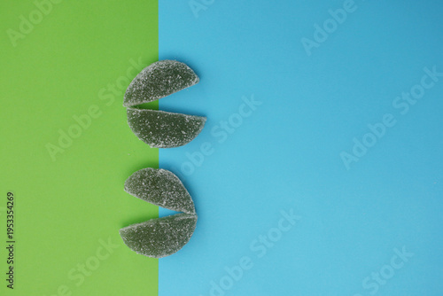 Four dark, glittery gummy pieces form a smile