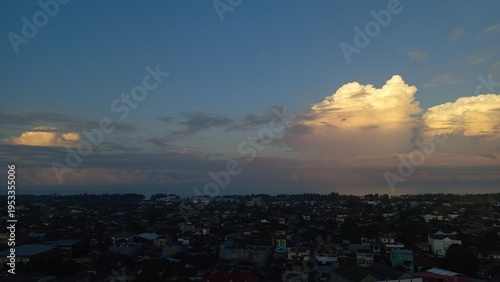 The calming atmosphere of the afternoon sky at sunset with a view of people's houses