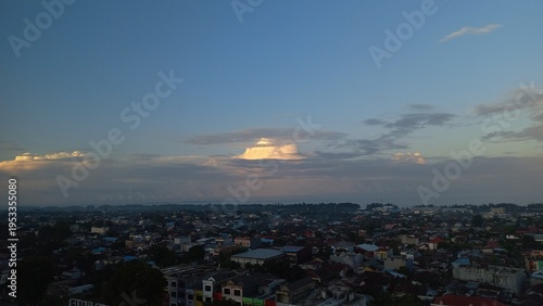 The calming atmosphere of the afternoon sky at sunset with a view of people's houses