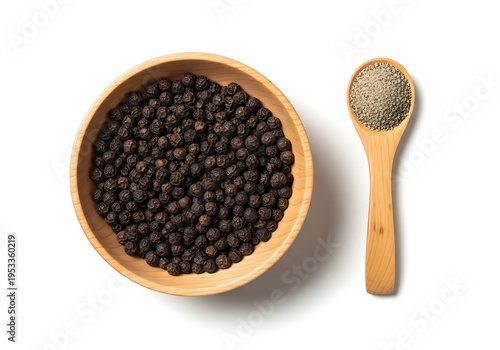 Whole black peppercorns in wooden bowl, spoon