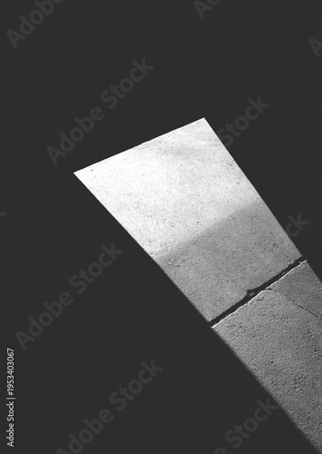 Close-up of a weathered, gray surface against a solid black backdrop