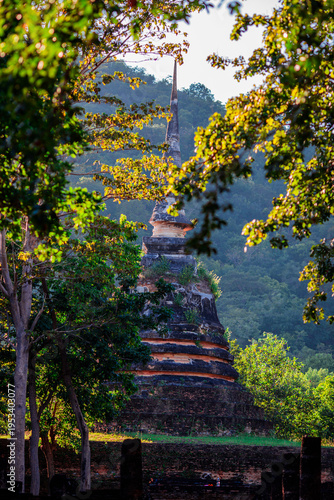 A natural backdrop of twilight sky and beautiful changing sunsets during a trip to Thailand, featuring mountains, rice fields, and temporary huts.