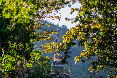 A natural backdrop of twilight sky and beautiful changing sunsets during a trip to Thailand, featuring mountains, rice fields, and temporary huts.