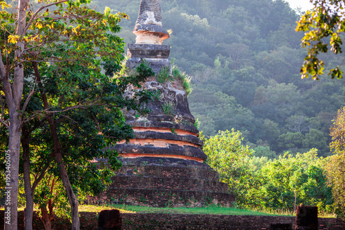 A natural backdrop of twilight sky and beautiful changing sunsets during a trip to Thailand, featuring mountains, rice fields, and temporary huts.