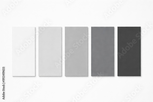 Five vertical paper swatches in shades of gray and white arranged in a row