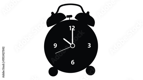 Classic alarm clock showing twelve o clock a striking black silhouette