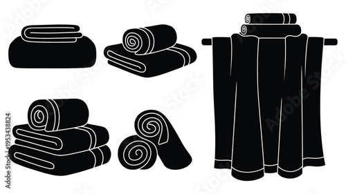 Black towels neatly arranged on a rack minimalist silhouette