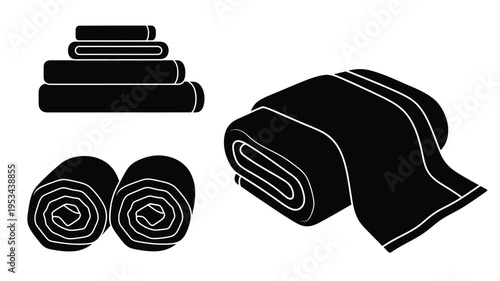 Folded and rolled towels presented in a striking black silhouette