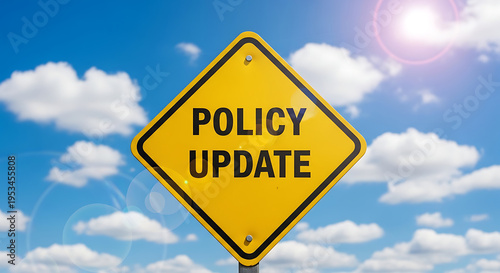 Important Policy Update warning sign against a vibrant blue sky with fluffy white clouds, signaling change and new regulations