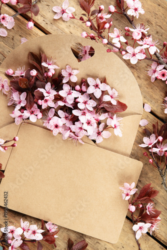 Cherry Blossoms in Kraft Envelope on Rustic Wooden Table