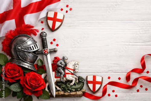 St George's Day celebration background with knight helmet, sword, roses and England flag on white wood.