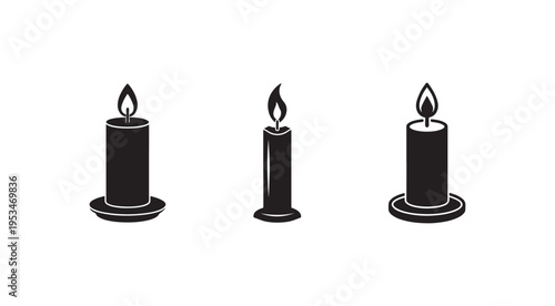 Three black candles with flames on top  isolated on white background